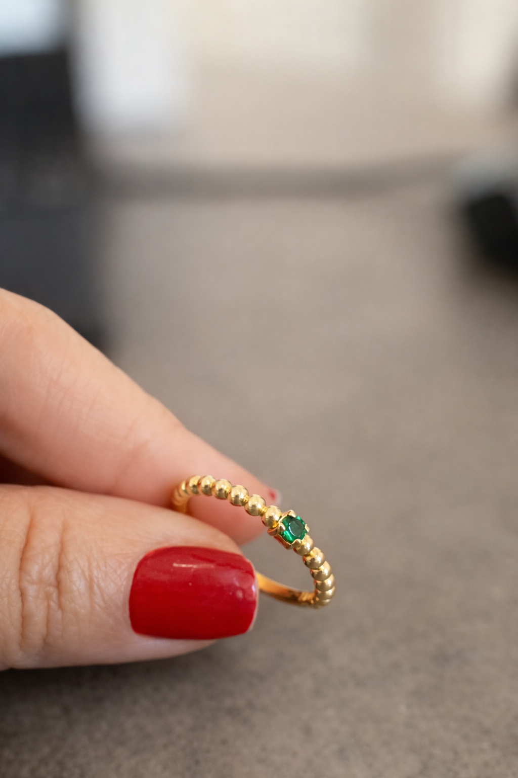 Beaded Ring with Green Zirconia held in hand