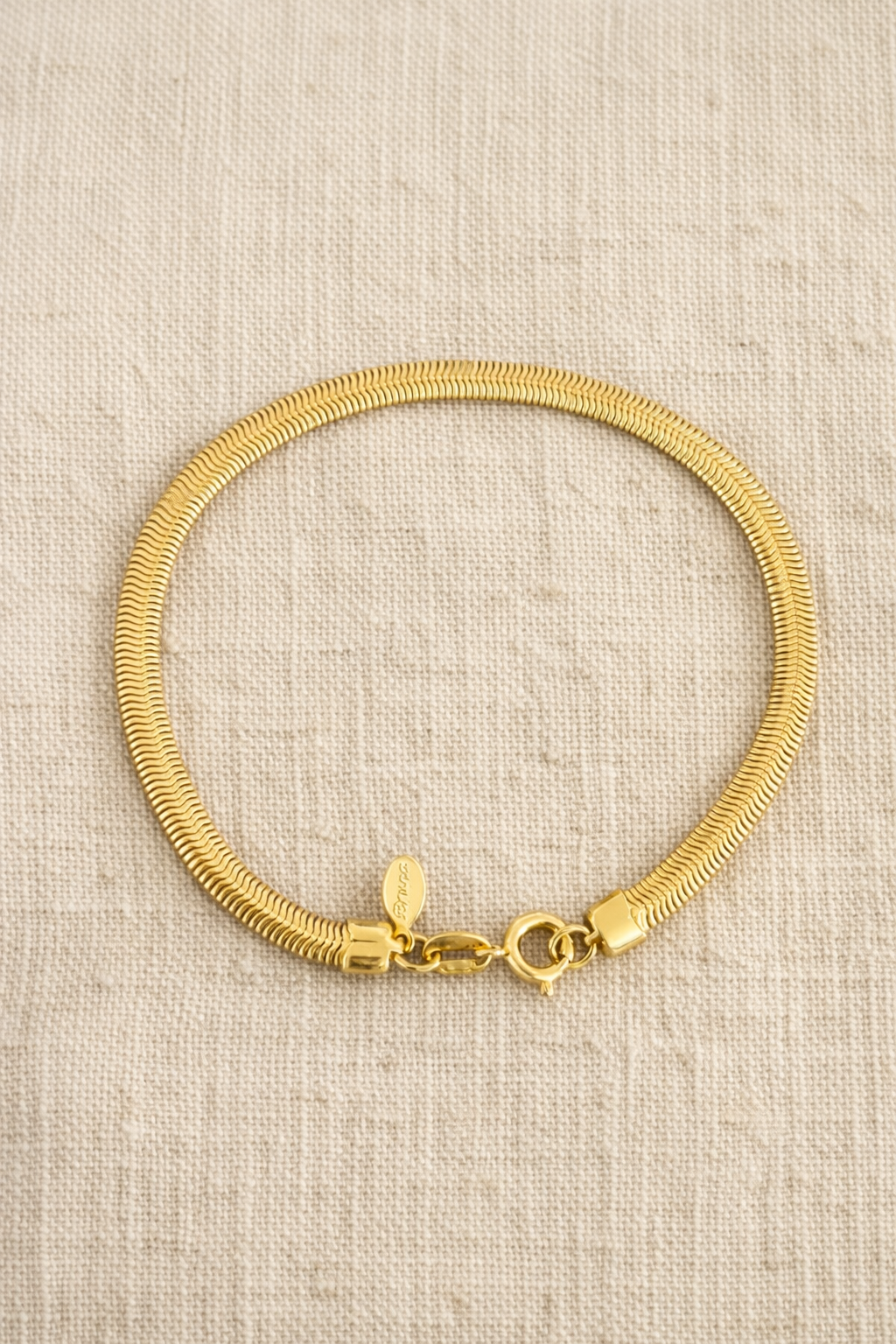 Snake Chain Bracelet on beige fabric