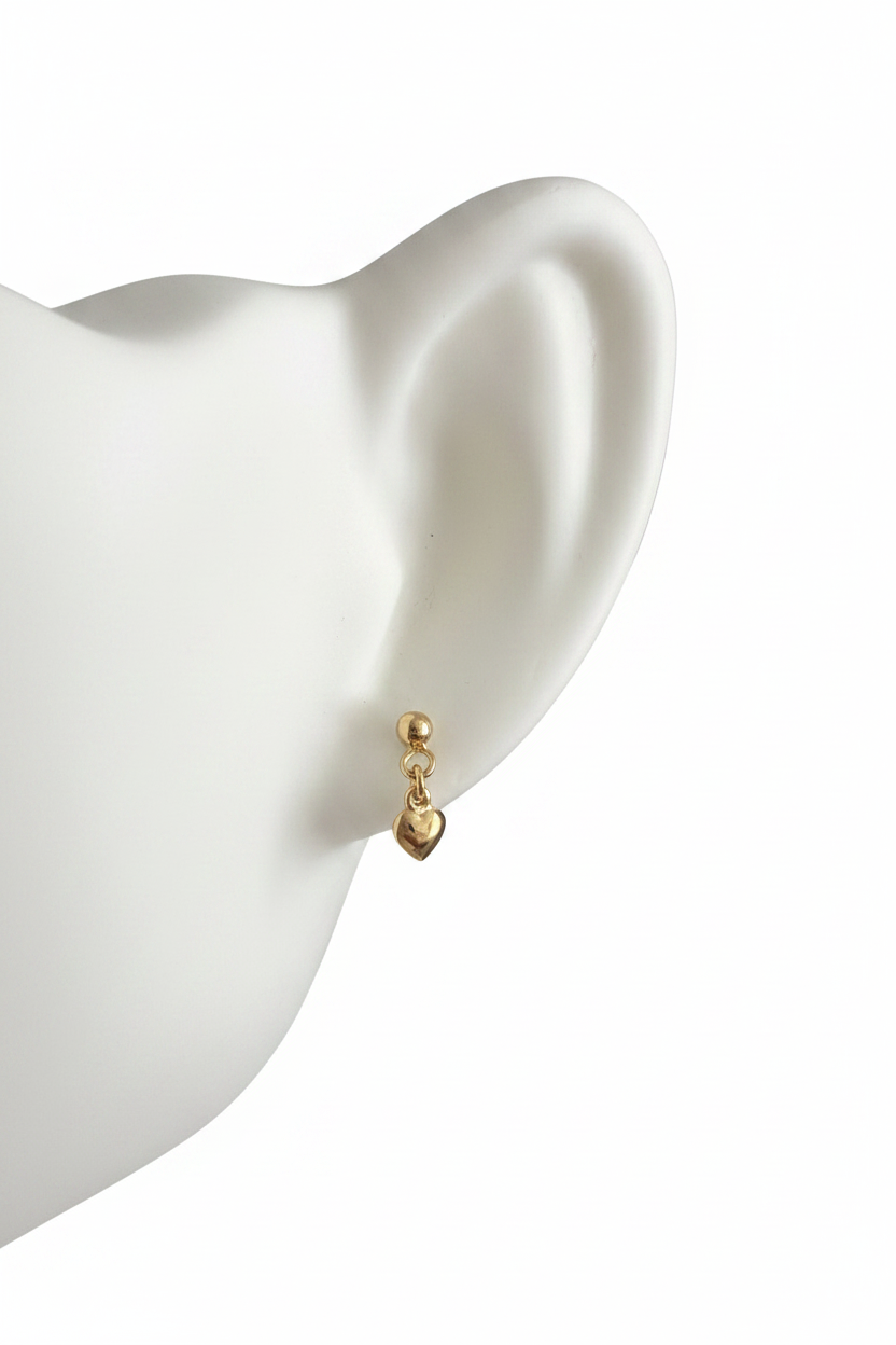 Children's gold heart drop earring on white background